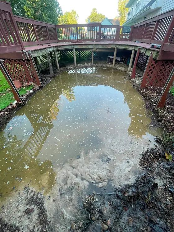The backyard after the pool was removed, showing the cleared ground under the deck